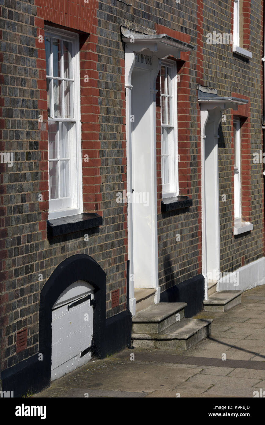 an old historic terrace of houses with cellar doors on the