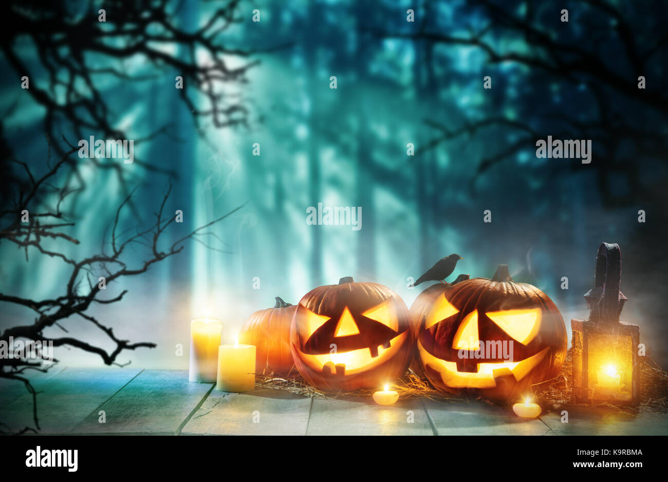 Spooky halloween pumpkins on wooden planks with dark horror background ...