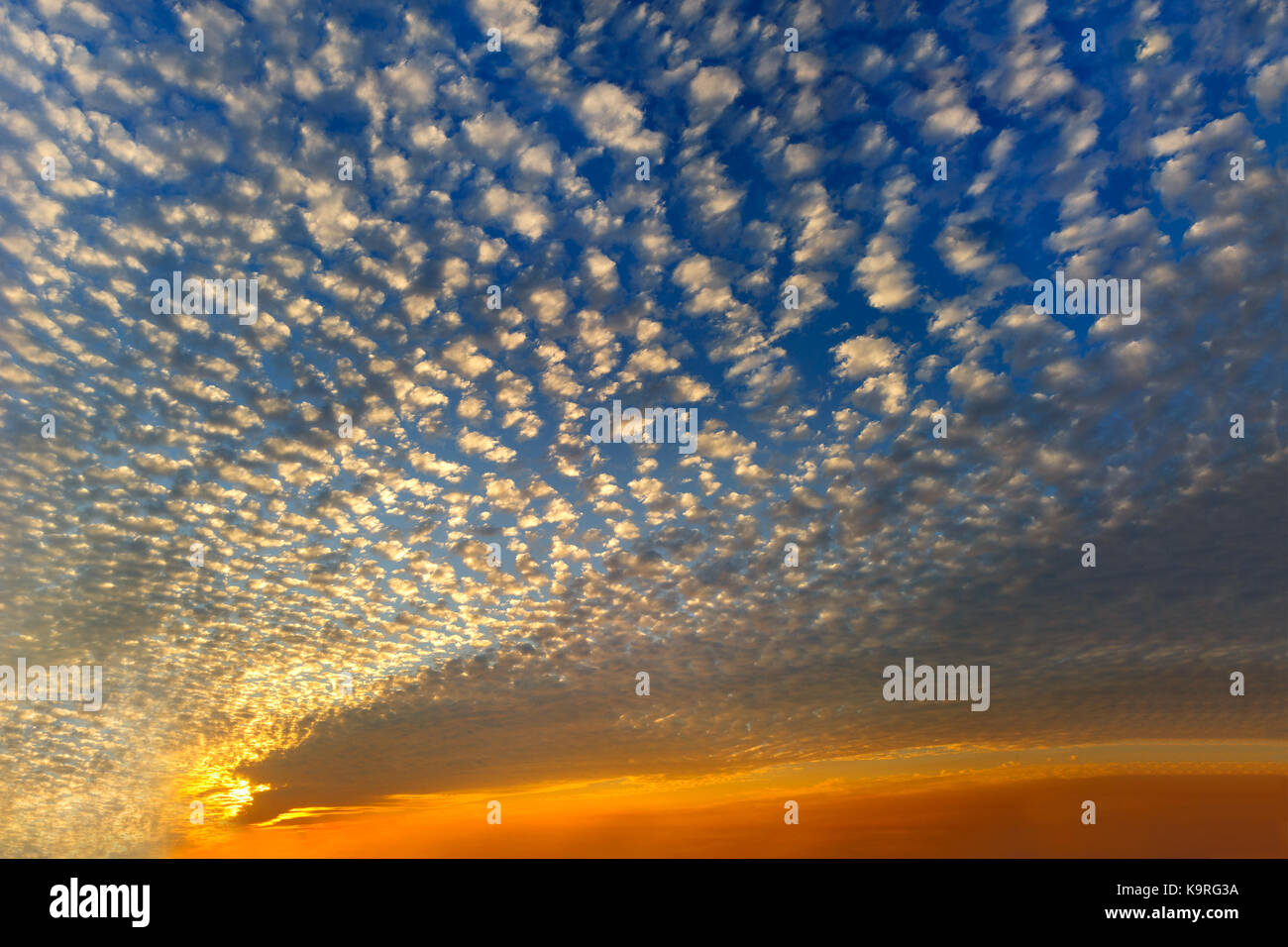 Sunset clouds is a sky filled with colorful patterned sunset clouds. Stock Photo
