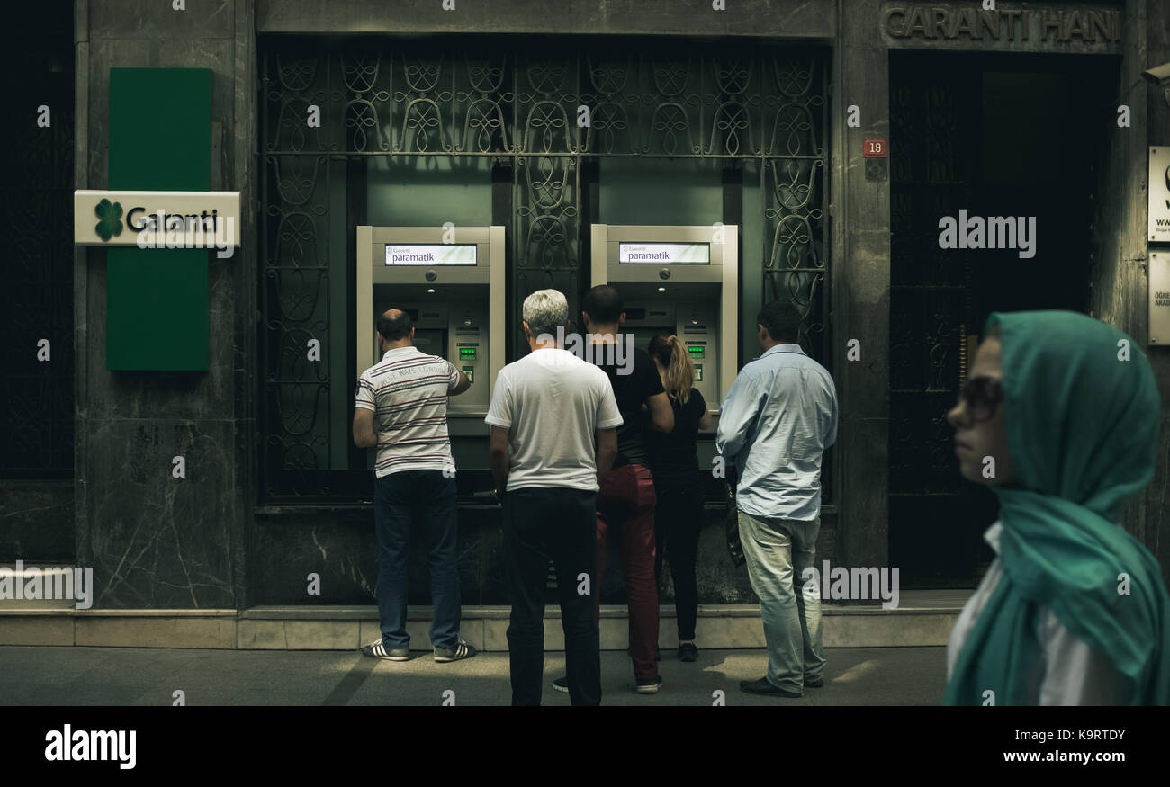 Istanbul, Turkey - September 20, 2017: People in a line at Garanti Bank ATM, Eminonu Stock Photo