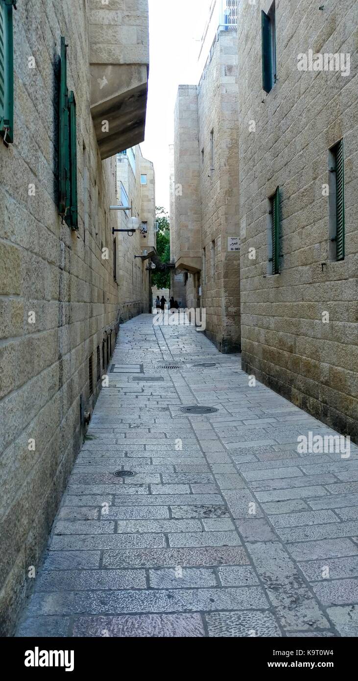 Stone alley in Jerusalem with children walking away Stock Photo