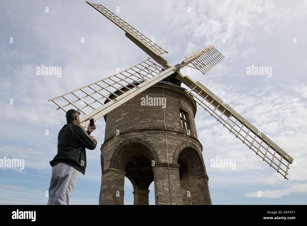 Ali Omar, 40, takes a photo of the Chesterton Windmill, a 17th-century cylindric stone tower windmill which is Grade 1 listed, outside the village of Chesterton, Warwickshire. Stock Photo