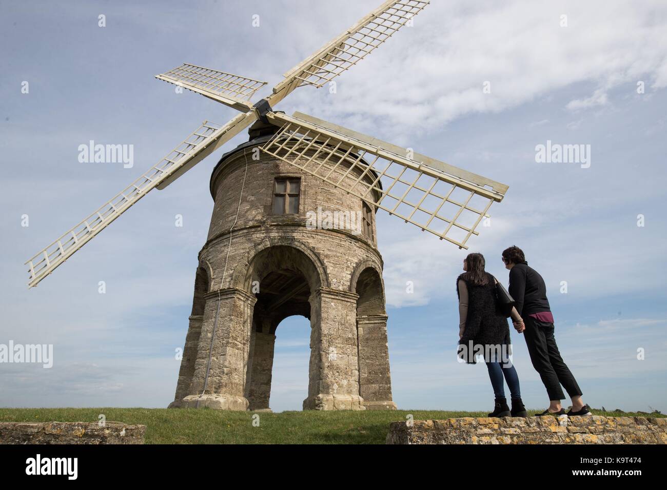 Kelly Gillett, 21, and Lin Boyle, 59, take a moment to look at the Chesterton Windmill, a 17th-century cylindric stone tower windmill which is Grade 1 listed, outside the village of Chesterton, Warwickshire. Stock Photo