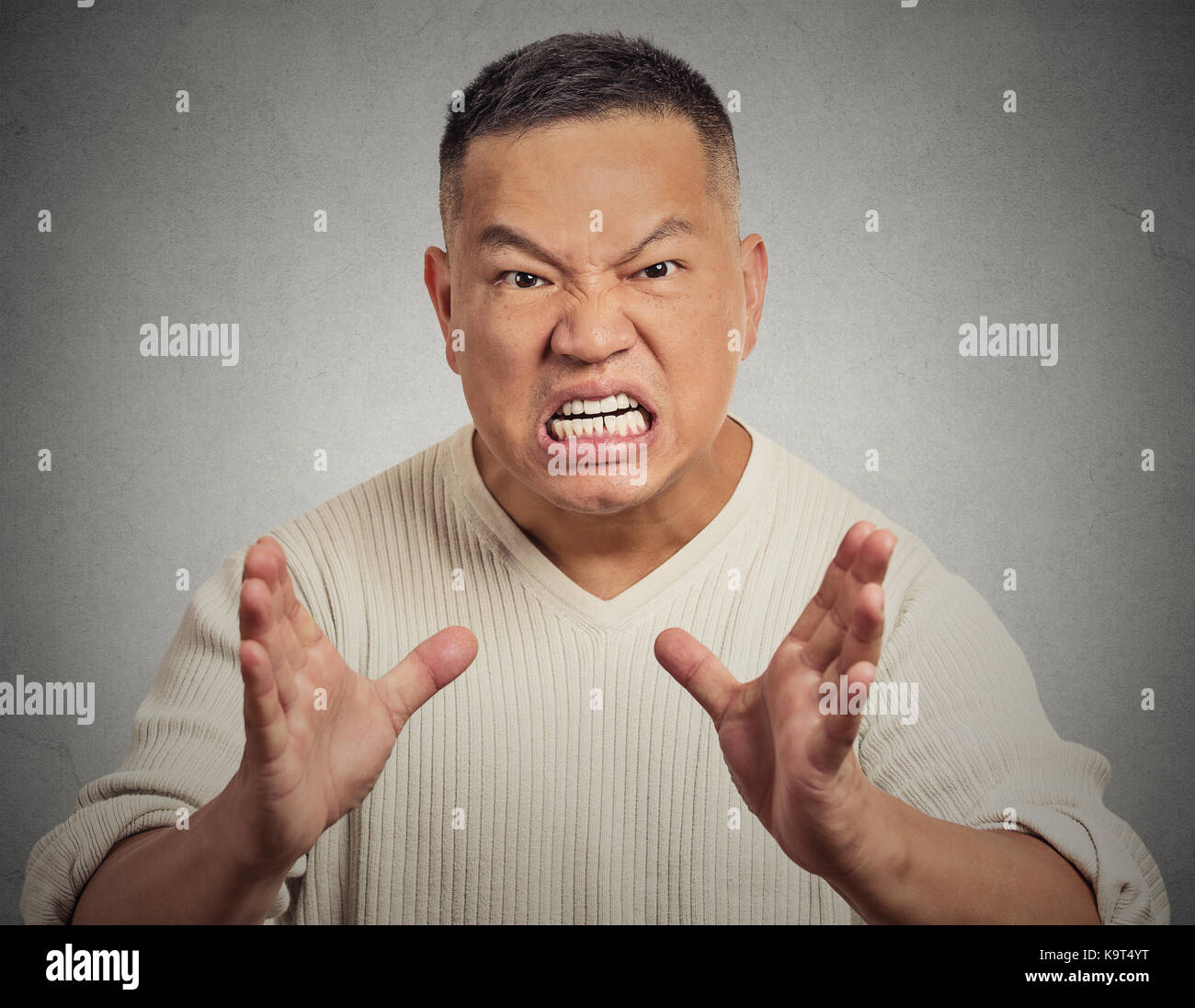 Portrait, bitter, displeased angry, grumpy man yelling screaming isolated grey wall background. Negative human emotion facial expression Stock Photo