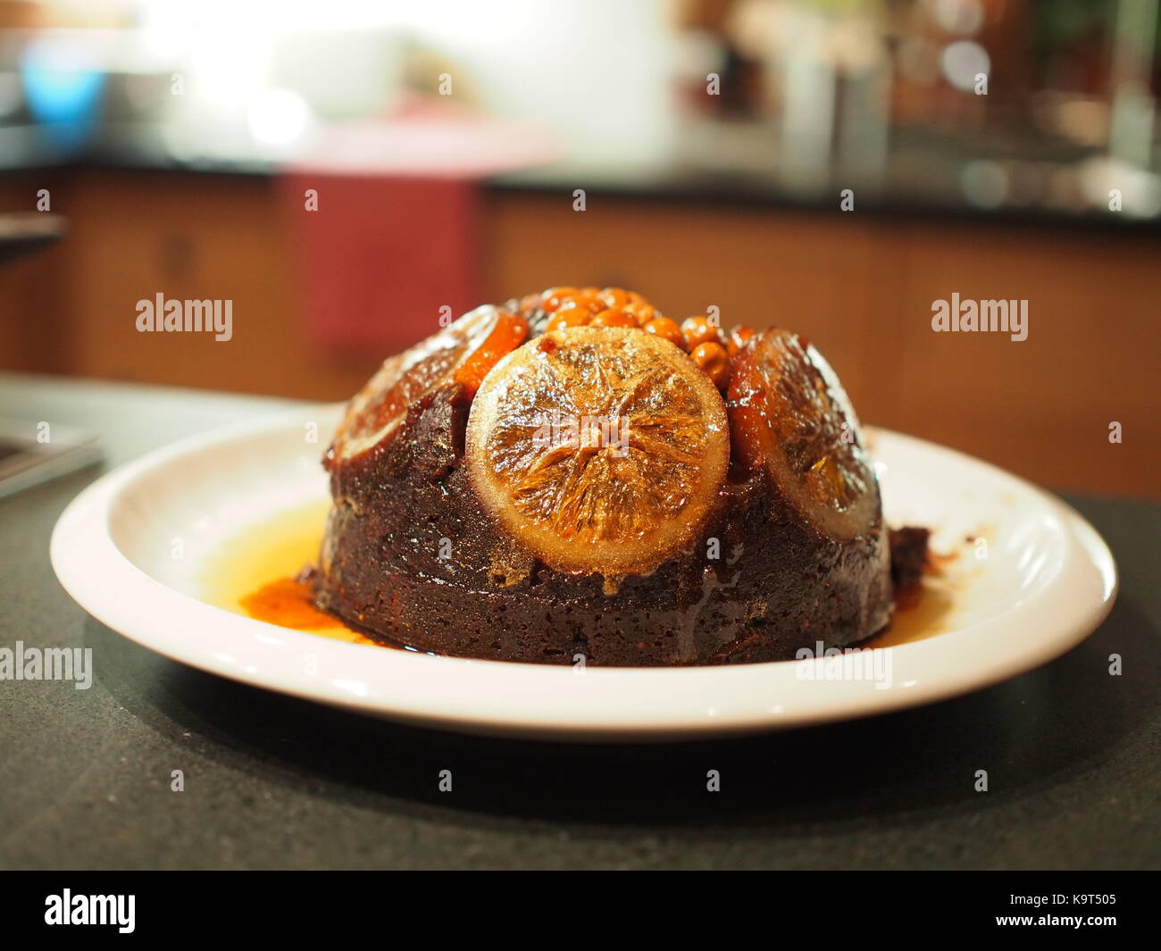 A Christmas pudding on a white plate Stock Photo
