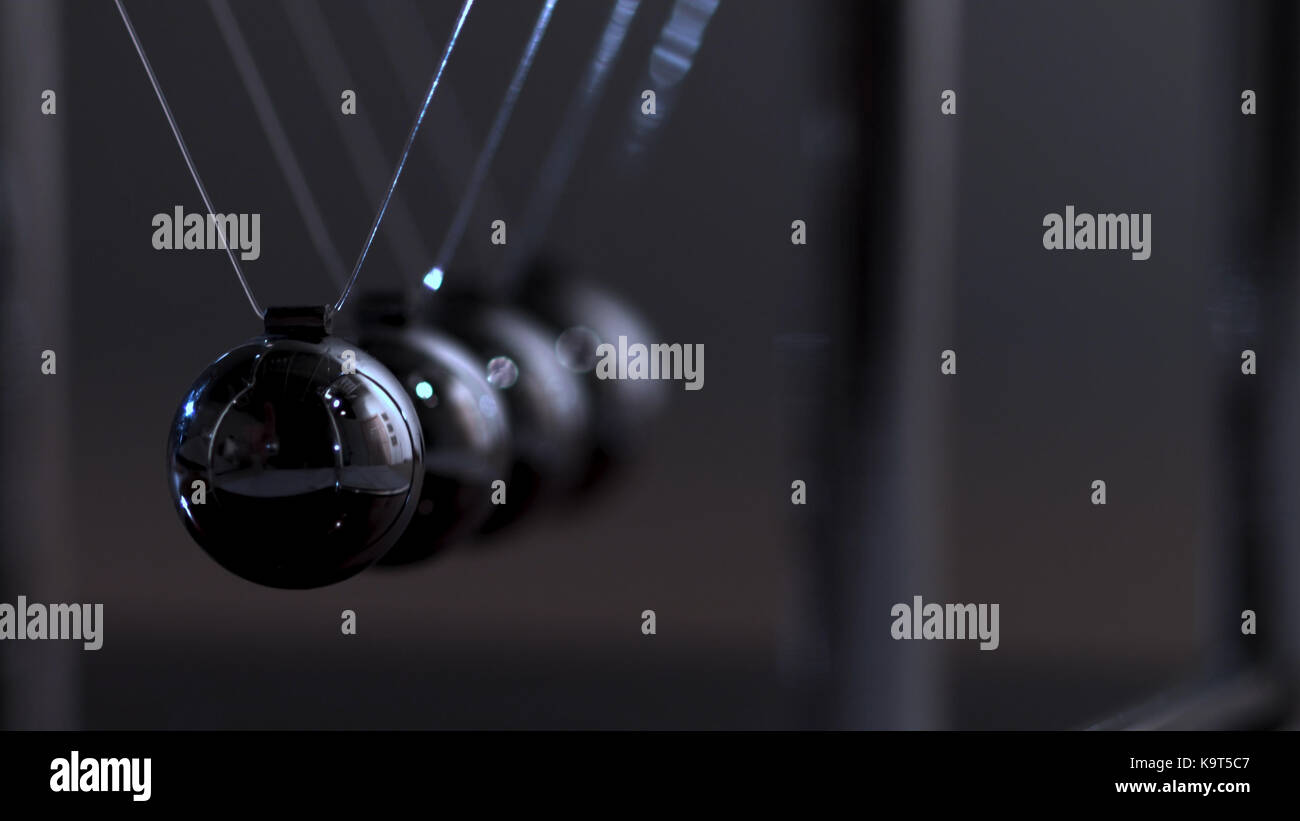 Newton's cradle physics concept for action and reaction or cause and