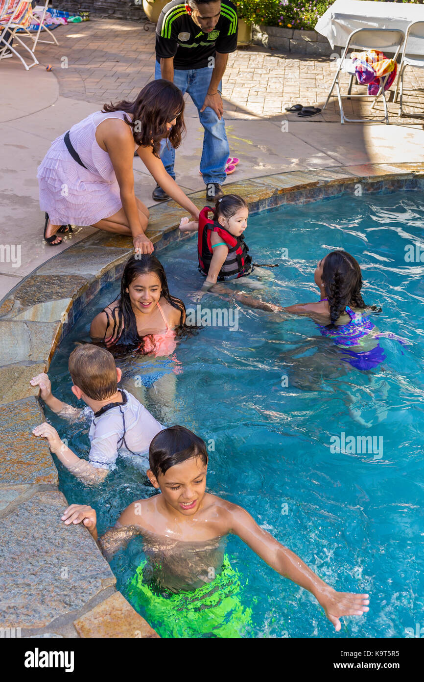 Hispanic children, playing in swimming pool, swimming pool, freshwater swimming pool, Castro Valley, Alameda County, California, United States Stock Photo