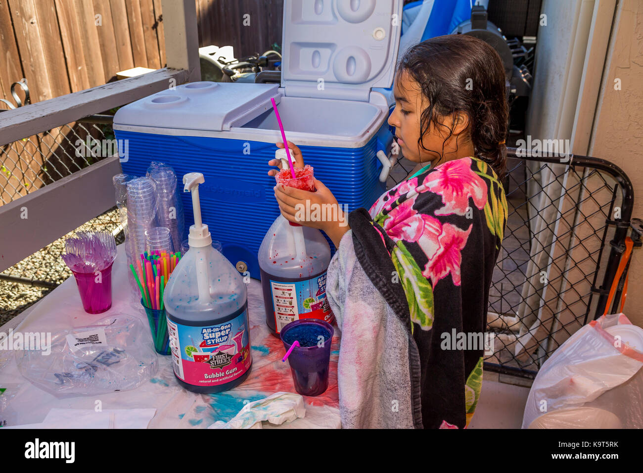 Hispanic girl, young girl, girl, making cherry flavored snow cone, pool party, Castro Valley, Alameda County, California, United States, North America Stock Photo