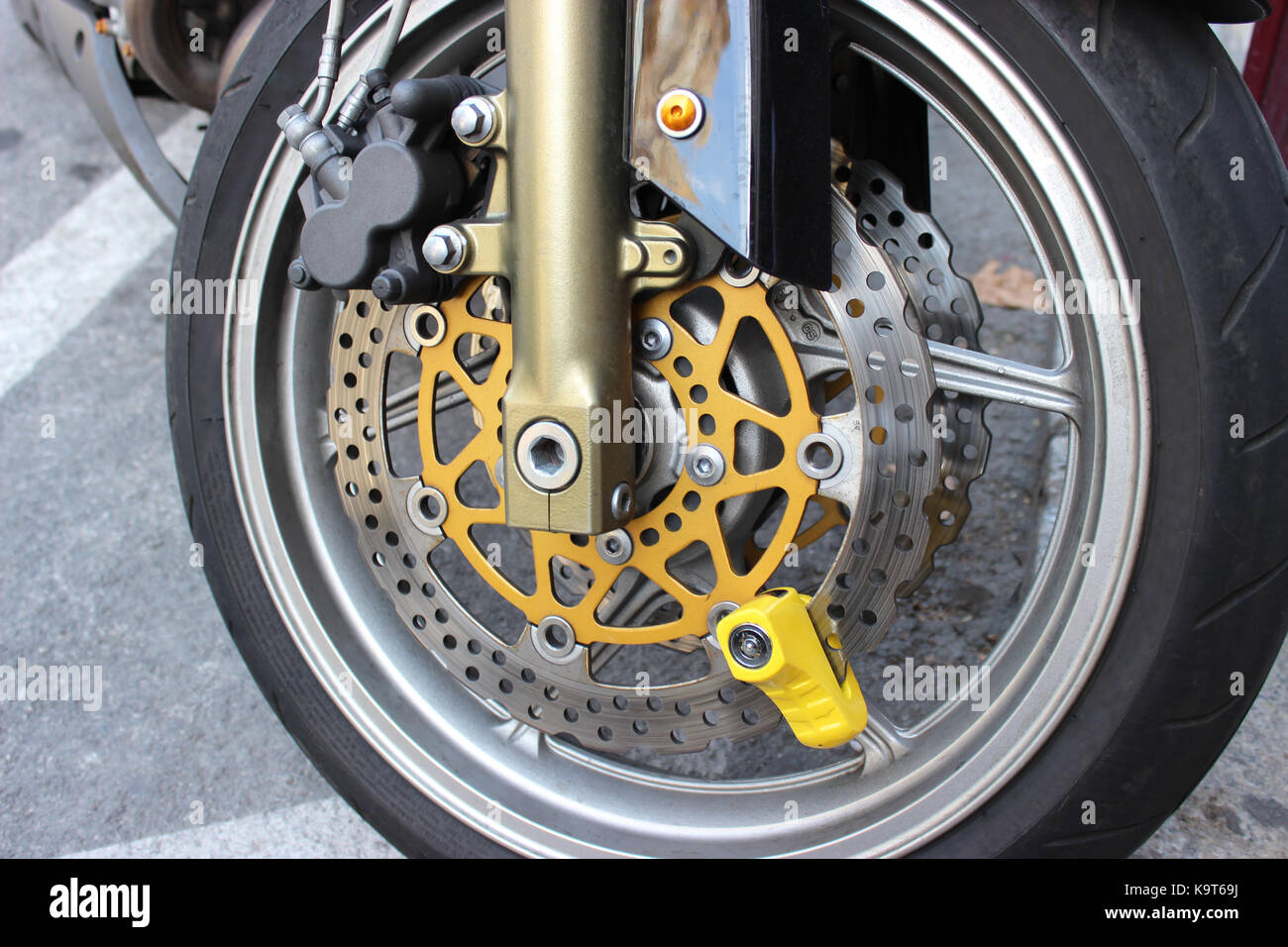 Yellow Disc Lock on Motorbike Disc Brake Stock Photo Alamy