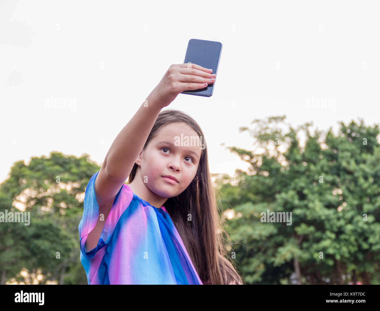 Young girl taking a selfie with a smartphone Stock Photo - Alamy