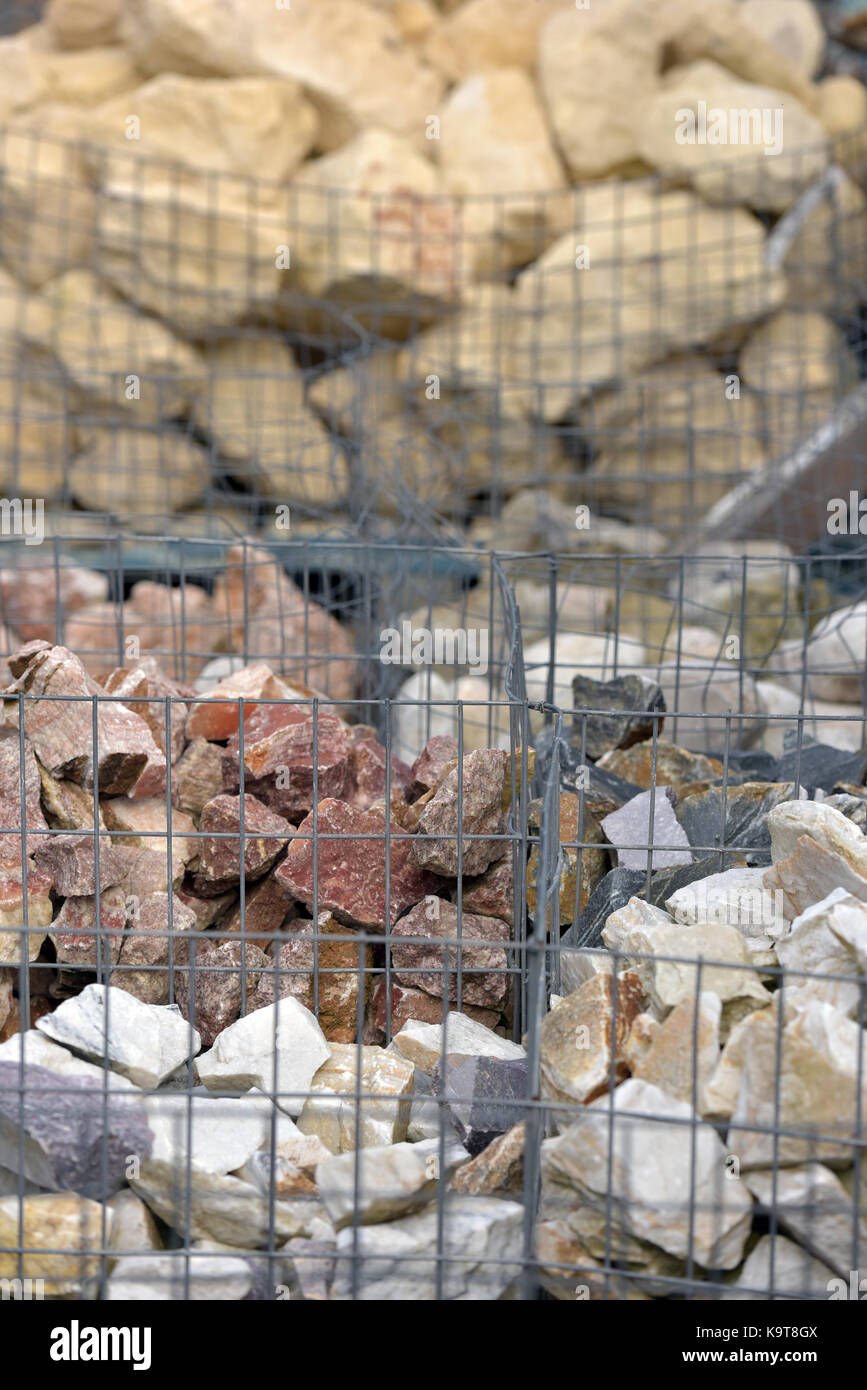 Building stones and materials in cages at builders merchants showing