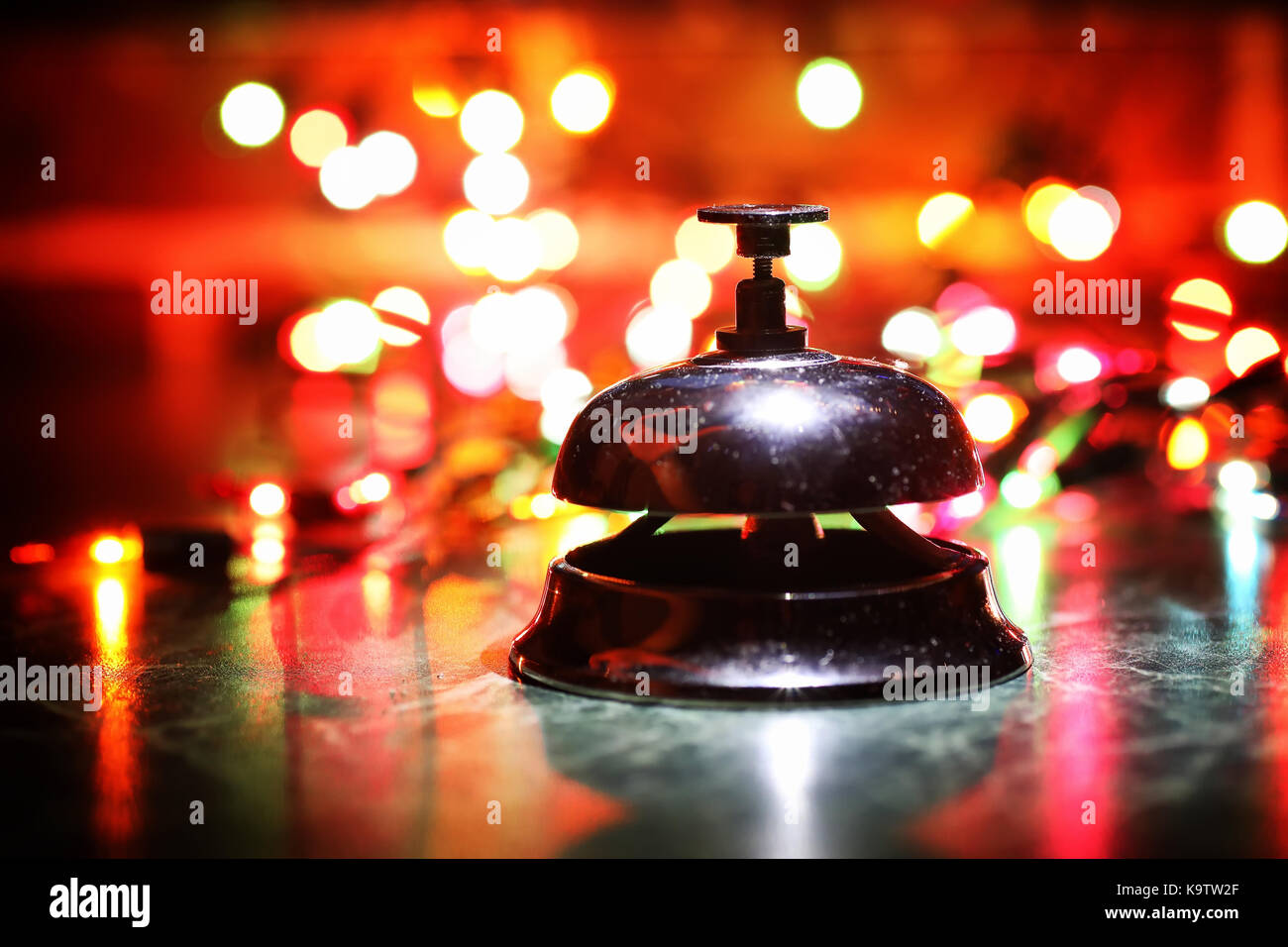 reception bell on table and color shining garland on background Stock ...