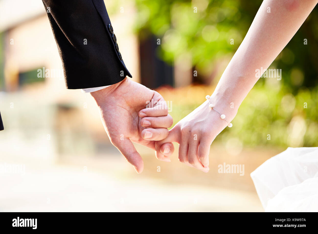 close-up shot of hands of a couple held together. Stock Photo