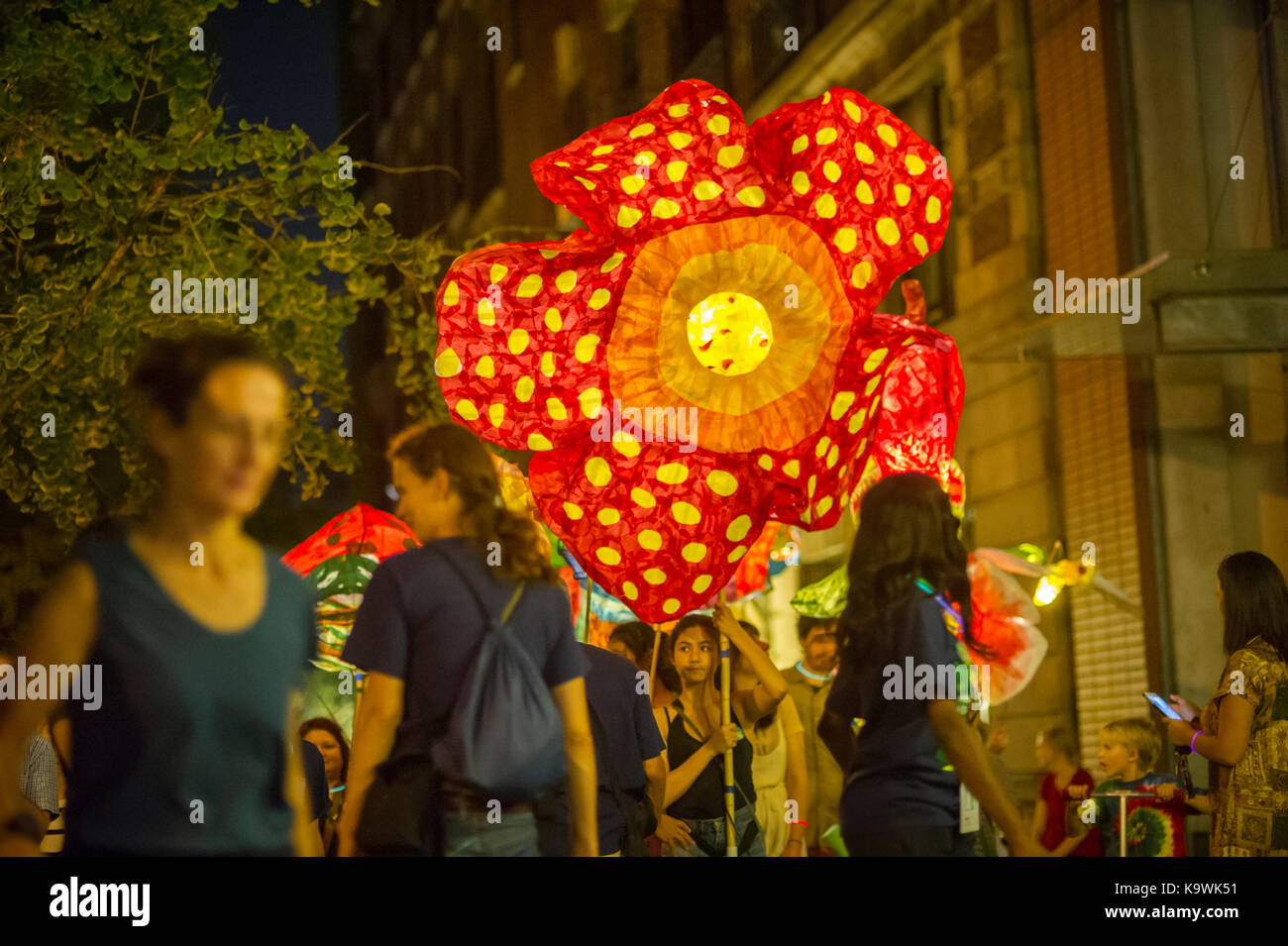 New York, USA. 23rd September, 2017. Local residents joined by Columbia University students and faculty carry lanterns created during the past week in the 6th annual Morningside Lights procession on Saturday, September 23, 2017. Produced by Columbia University Arts Initiative and Miller Theatre, the paper-mâché illuminated lanterns  fulfilled the theme of this years' procession; 'Secret Gardens', commemorating the gardens of the Harlem and Morningside neighborhoods. Credit: Richard Levine/Alamy Live News Stock Photo