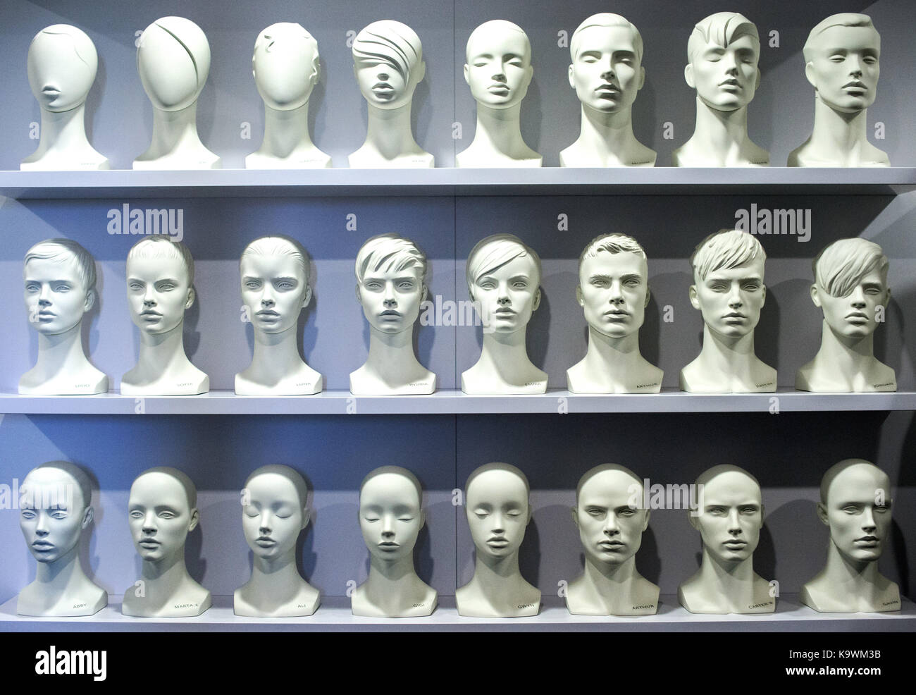 Differently designed heads of female and male mannequins are on display