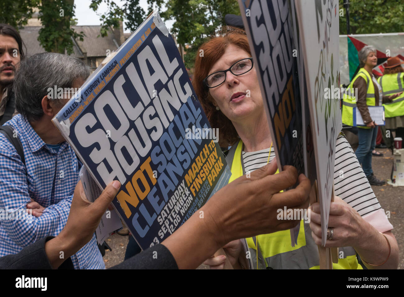 London, UK. 23rd Sep, 2017. London, UK. 23rd September 2017. A steward hands out placards at the rally before the march by hundreds in North London from a rally in Tottenham to Finsbury Park against the so called Haringey Development Vehicle, under which Haringey Council is making a huge transfer of council housing to Australian multinational Lendlease. This will result in the imminent demolition of over 1,300 council homes on the Northumberland Park estate, followed by similar loss of social housing across the whole of the borough. At Â£2 billion, his is the largest giveaway of council Stock Photo