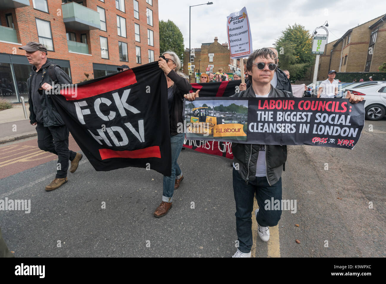 London, UK. 23rd Sep, 2017. London, UK. 23rd September 2017. Sid Skill of Class War holds a banner 'Labour Councils: The Biggest Social Cleansers In London ' on the in North London from a rally in Tottenham to Finsbury Park against the so called Haringey Development Vehicle, under which Haringey Council is making a huge transfer of council housing to Australian multinational Lendlease. This will result in the imminent demolition of over 1,300 council homes on the Northumberland Park estate, followed by similar loss of social housing across the whole of the borough. At Â£2 billion, his is Stock Photo