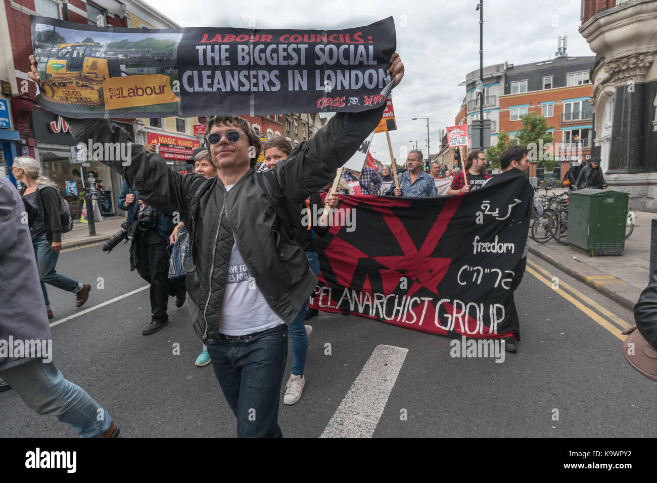 London, UK. 23rd Sep, 2017. London, UK. 23rd September 2017. Sid Skill of Class War holds a banner 'Labour Councils: The Biggest Social Cleansers In London ' on the in North London from a rally in Tottenham to Finsbury Park against the so called Haringey Development Vehicle, under which Haringey Council is making a huge transfer of council housing to Australian multinational Lendlease. This will result in the imminent demolition of over 1,300 council homes on the Northumberland Park estate, followed by similar loss of social housing across the whole of the borough. At Â£2 billion, his is Stock Photo