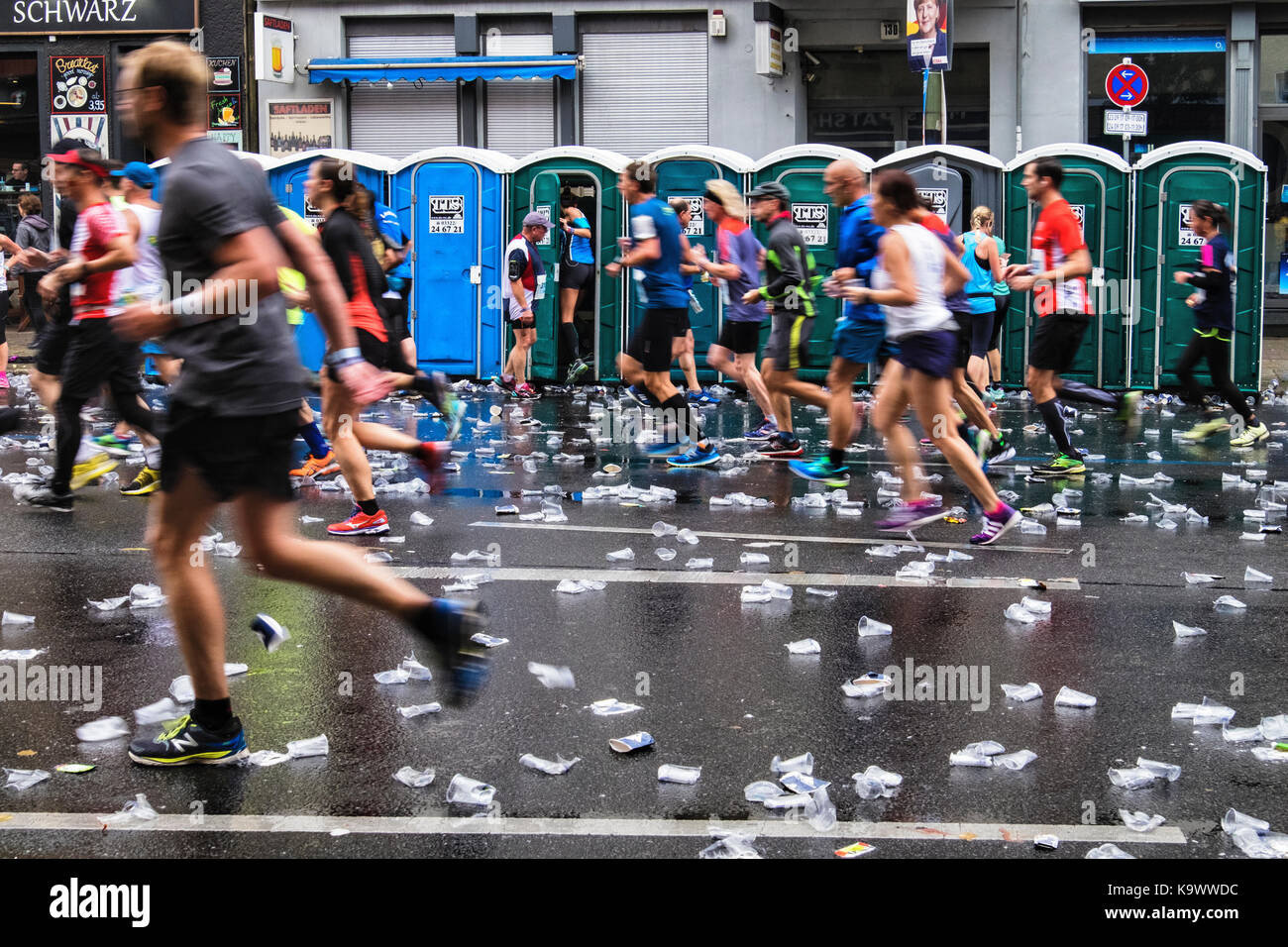 Berlin, Germany, 24th September, 2017. Toilets for runners. Athletes  competing in the Berlin Marathon reach the 10 Kilometer mark at  Rosenthalerplatz. The wet weather did nor appear to dampen the spirits of