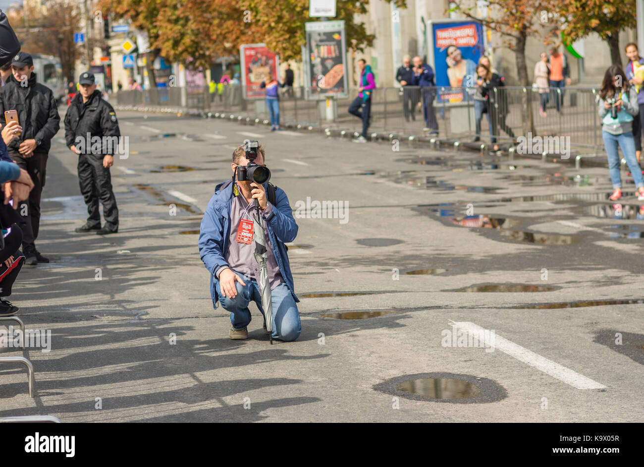 DNEPR, UKRAINE - SEPTEMBER 24, 2017:Accredited sitting on a street and waiting for race start during 'Dnipro ATB Marathon' on the city street at September 24, 2017 in Dnepr, Ukraine Credit: Yuri Kravchenko/Alamy Live News Stock Photo