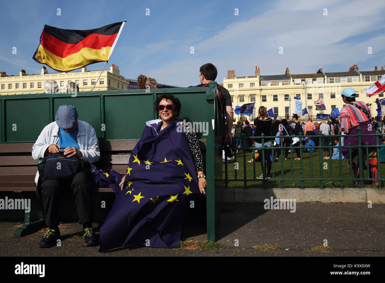 Brighton, UK. 24th September, 2017. A Pro European Union supporters sits in the sun with an EU flag 'covering her during a protest against Brexit in Brighton, UK, Sunday, September 24, 2017. Protesters rallied outside the annual Labour Party Conference being held in Brighton and attended by the opposition leader Jeremy Corbyn. Photograph : Credit: Luke MacGregor/Alamy Live News Stock Photo