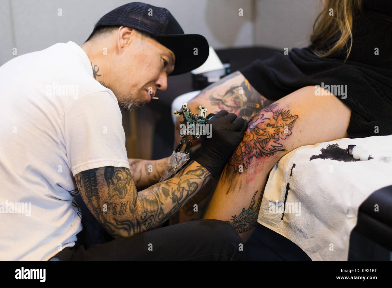 London UK 24th September 2017 A tattoo artist works on a womans tattoo  at the London Tattoo Convention 2017 held at at Tobacco Dock Credit  Vickie FloresAlamy Live News Stock Photo  Alamy