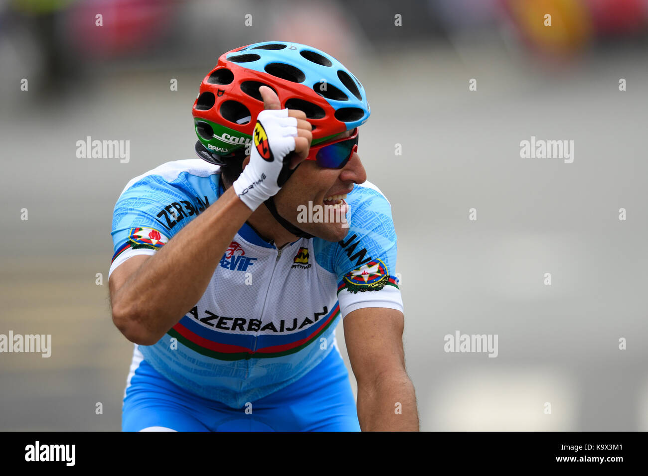 Bergen, Norway. 24th September, 2017. Elchin Asadov (Azerbaijan) was part of the early ten men breakway group. As the group got reeled in and the breakaway riders struggled with the peloton pace, and got dropped. Elchin Asadov was still all smiles and thanked the specatators along the course, before he abandoned the race for a DNF. Credit: Kjell Eirik Irgens Henanger/Alamy Live News Stock Photo