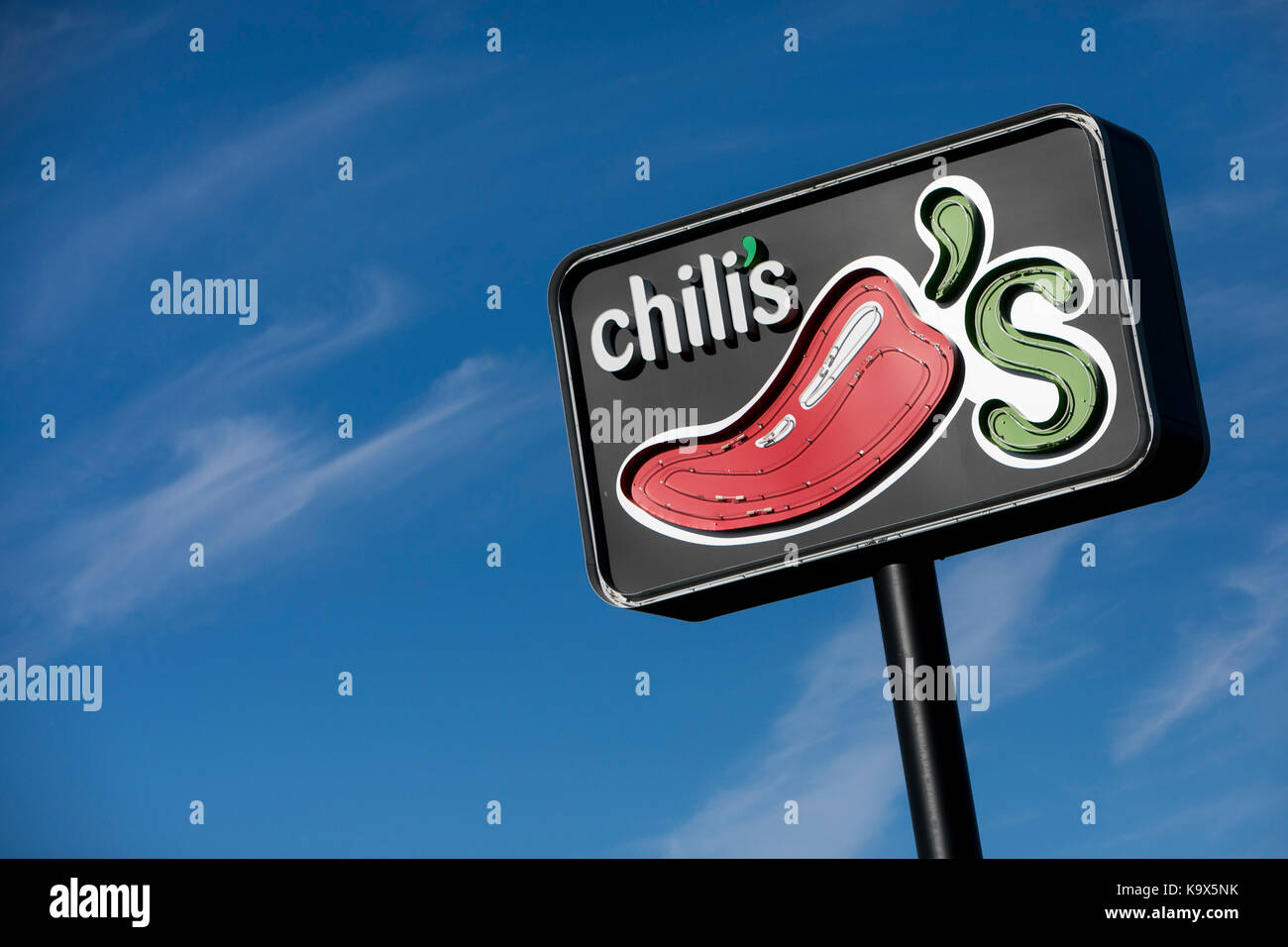 A logo sign outside of a Chili's Grill & Bar restaurant location in ...