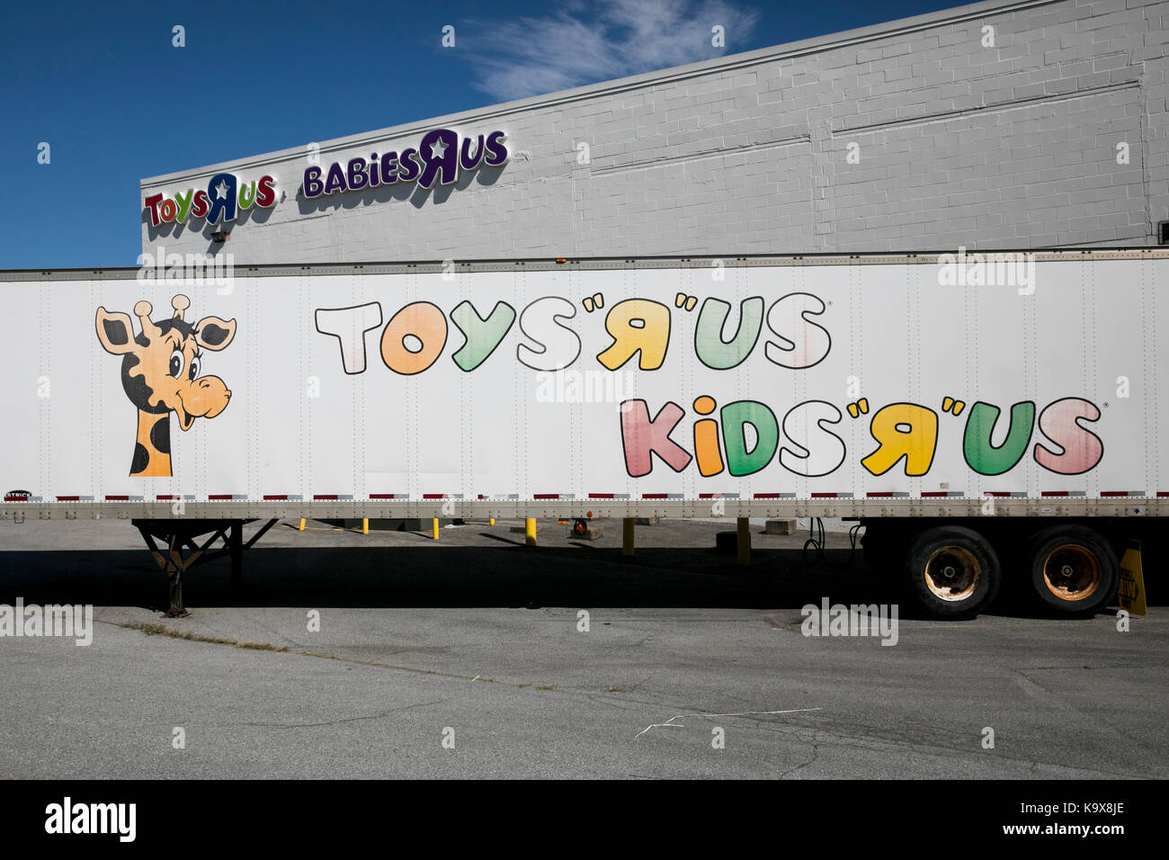 A logo sign outside of a Toys "R" Us and Babies "R" Us retail store in