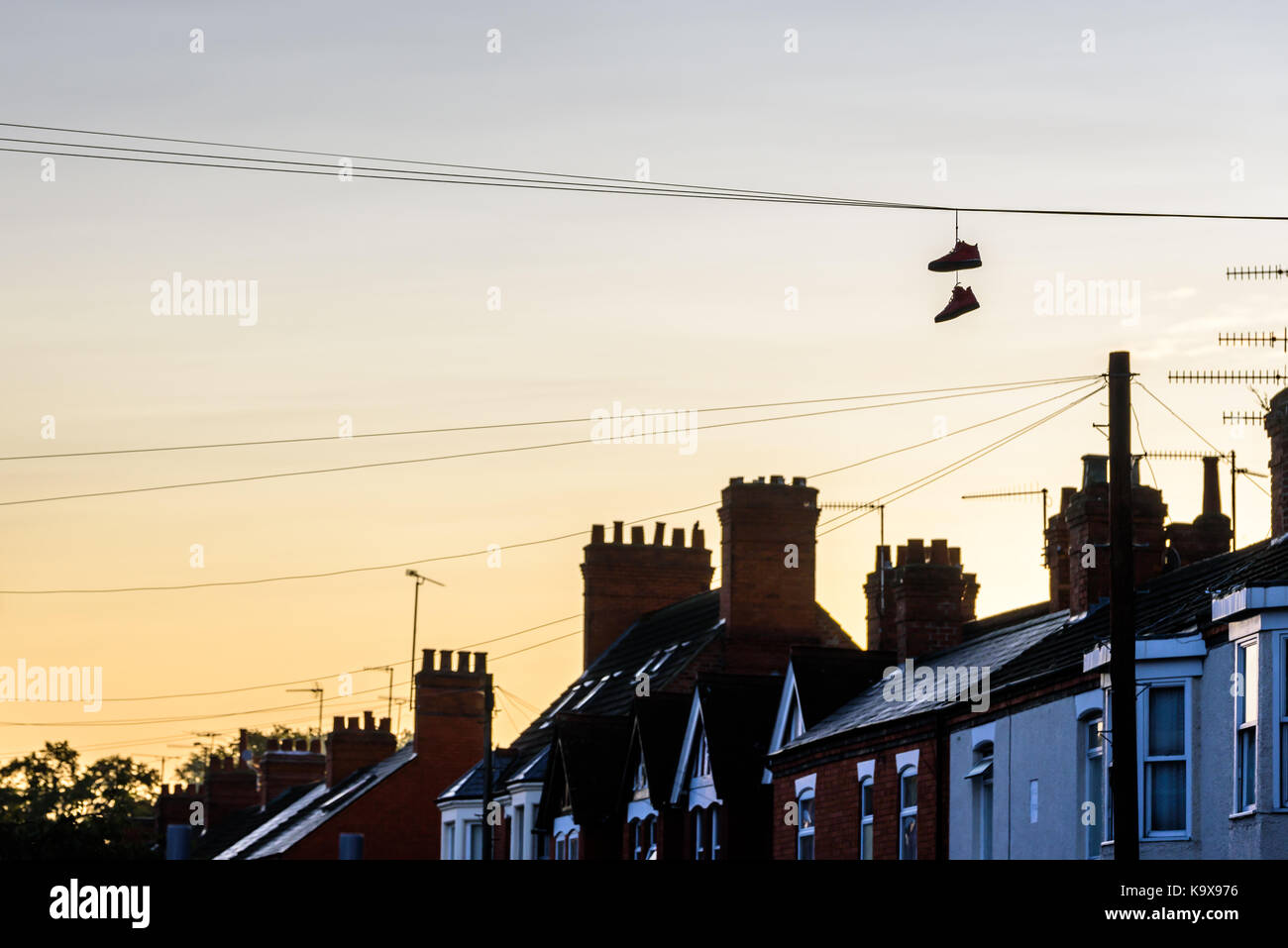 Pair of boots hanging on power lines in English Town Stock Photo Alamy