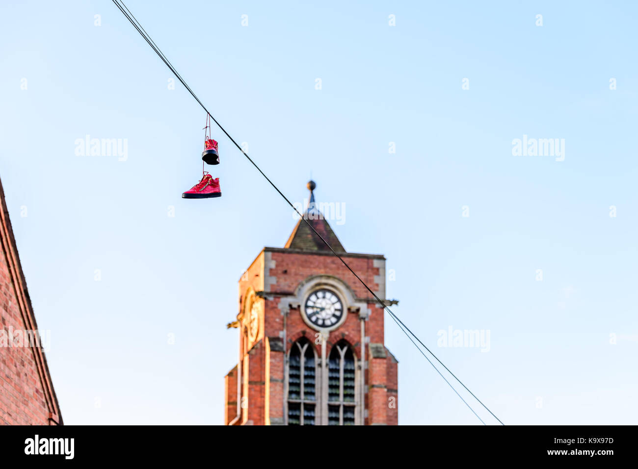 Pair of boots hanging on power lines in English Town Stock Photo Alamy