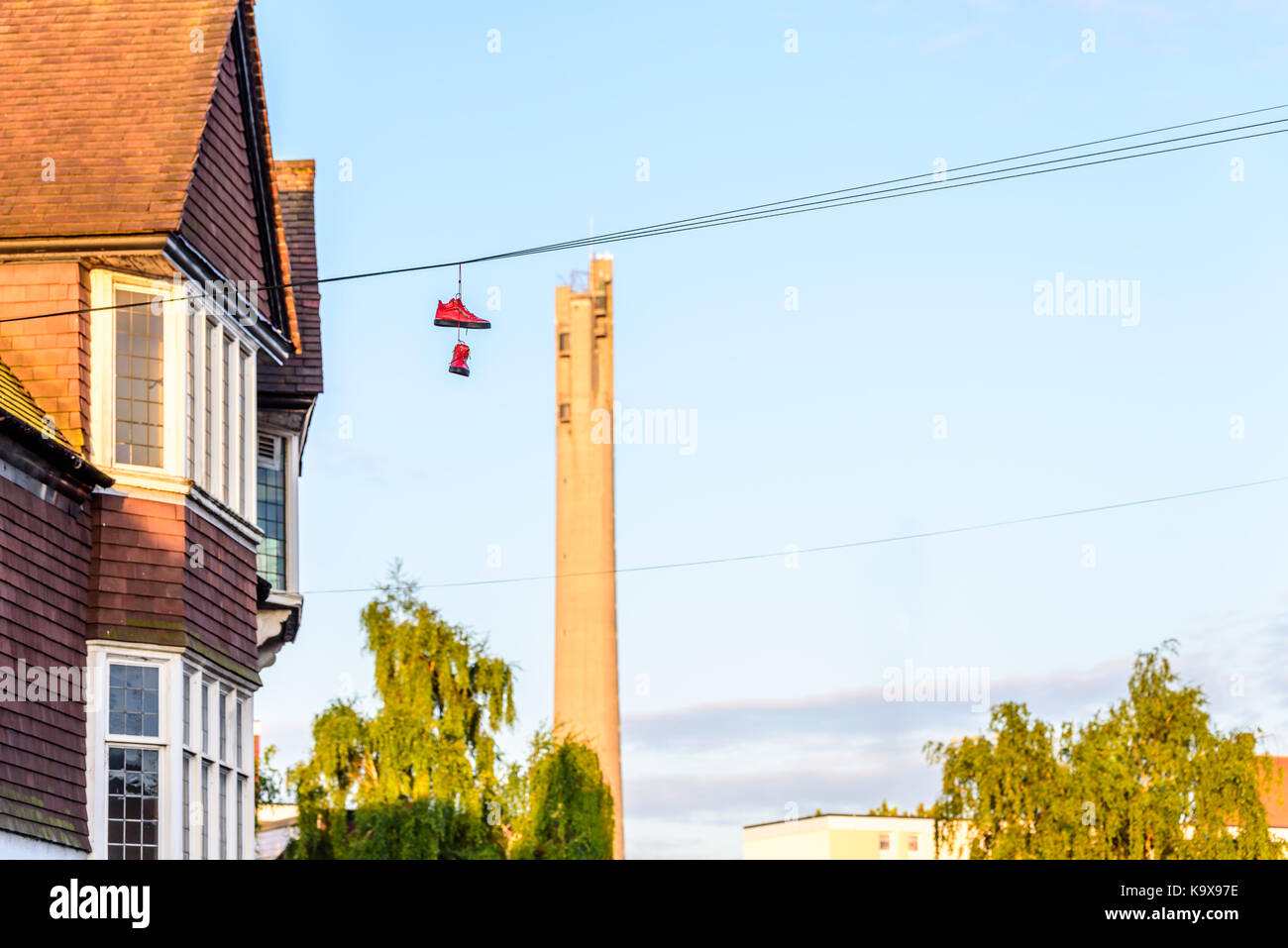 Pair of boots hanging on power lines in English Town Stock Photo Alamy