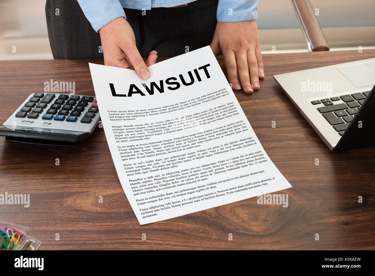 Close-up Lawyer Showing The Document With The Text Lawsuit Stock Photo