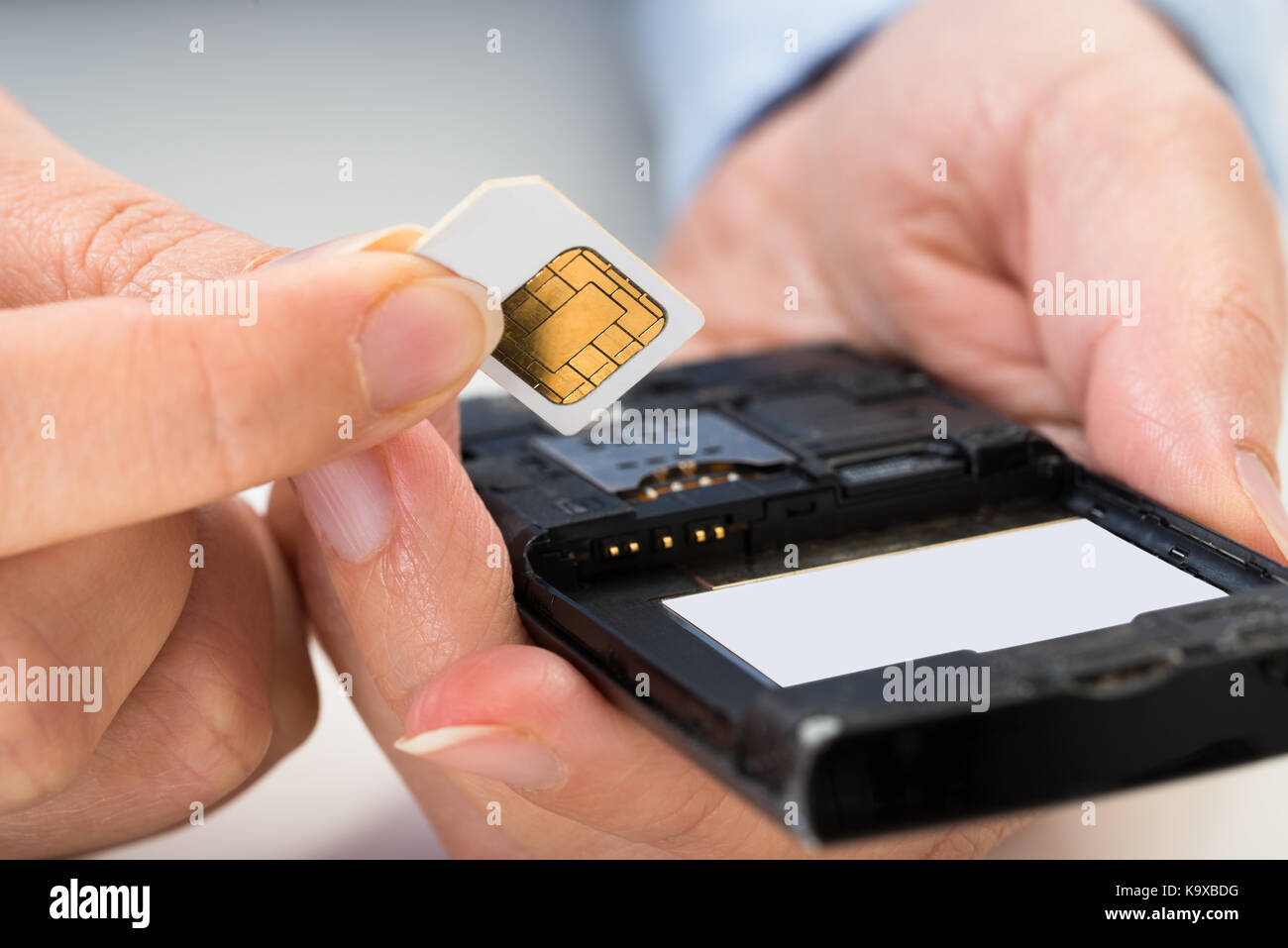 Close-up Of Person Hand Inserting A Sim Card Into Mobile Phone Stock ...