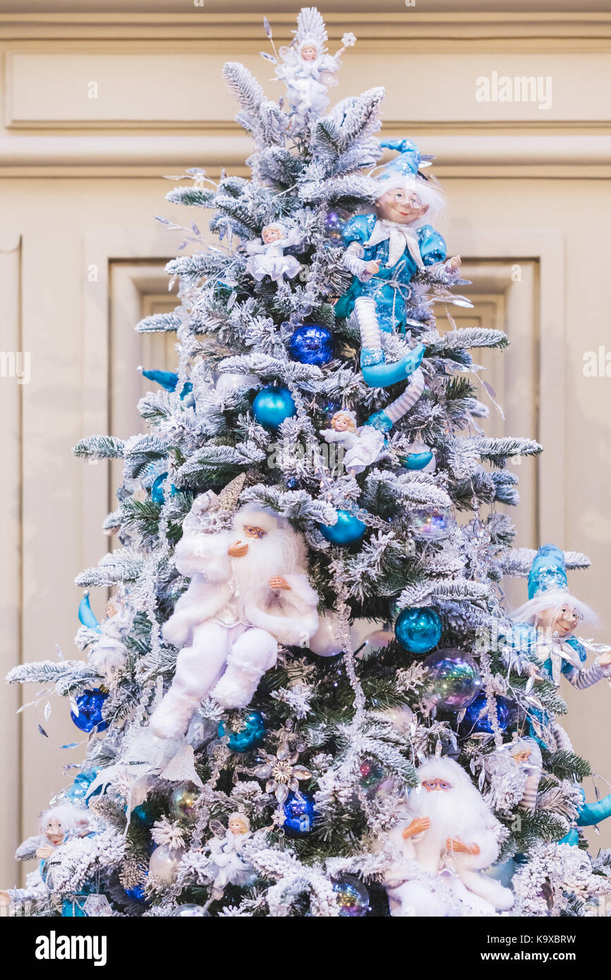 Christmas tree decorated with artificial snow, blue balls and figurines fairy-tale characters Stock Photo