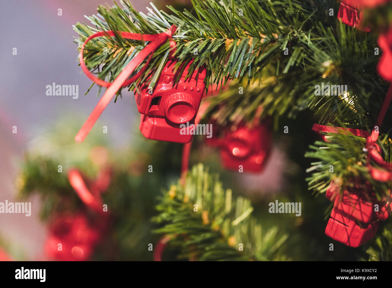 Christmas tree decorated with small figures of red photo cameras Stock