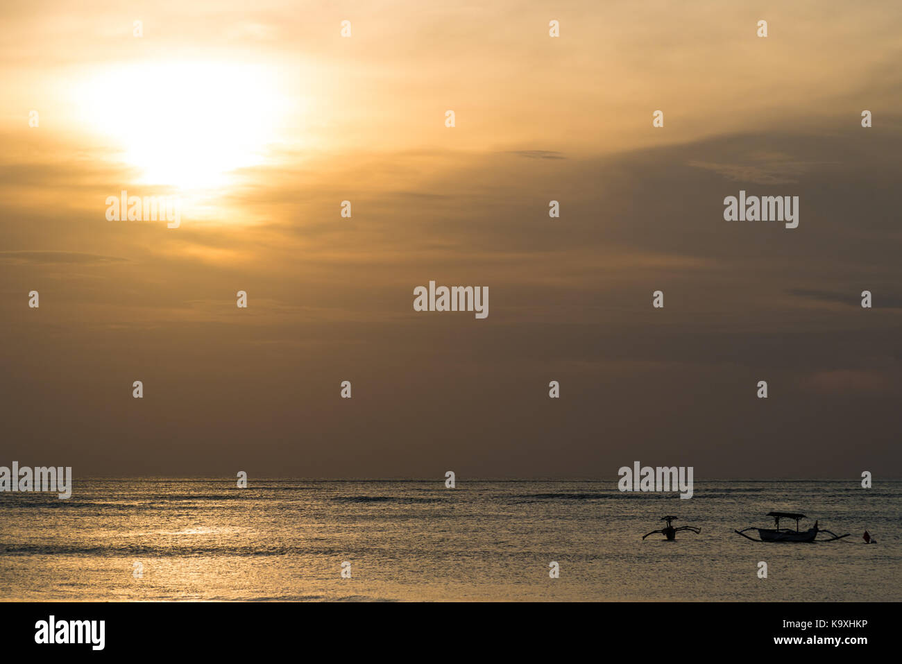Silhouettes of fishing boats at sunset in Bali Stock Photo - Alamy
