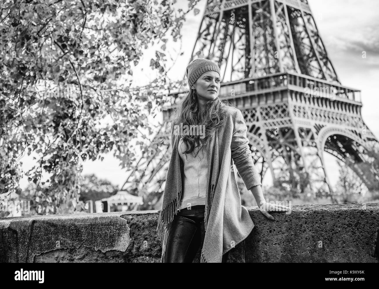 Autumn getaways in Paris. pensive young tourist woman on embankment near Eiffel tower in Paris, France looking into the distance Stock Photo