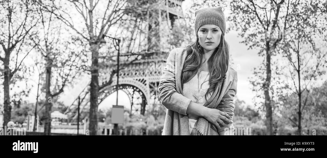 Autumn getaways in Paris. Portrait of young woman in Paris, France standing in front of Eiffel tower Stock Photo