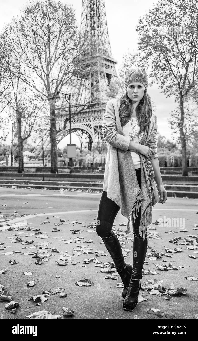 Autumn getaways in Paris. Full length portrait of young elegant woman in Paris, France standing in front of Eiffel tower Stock Photo