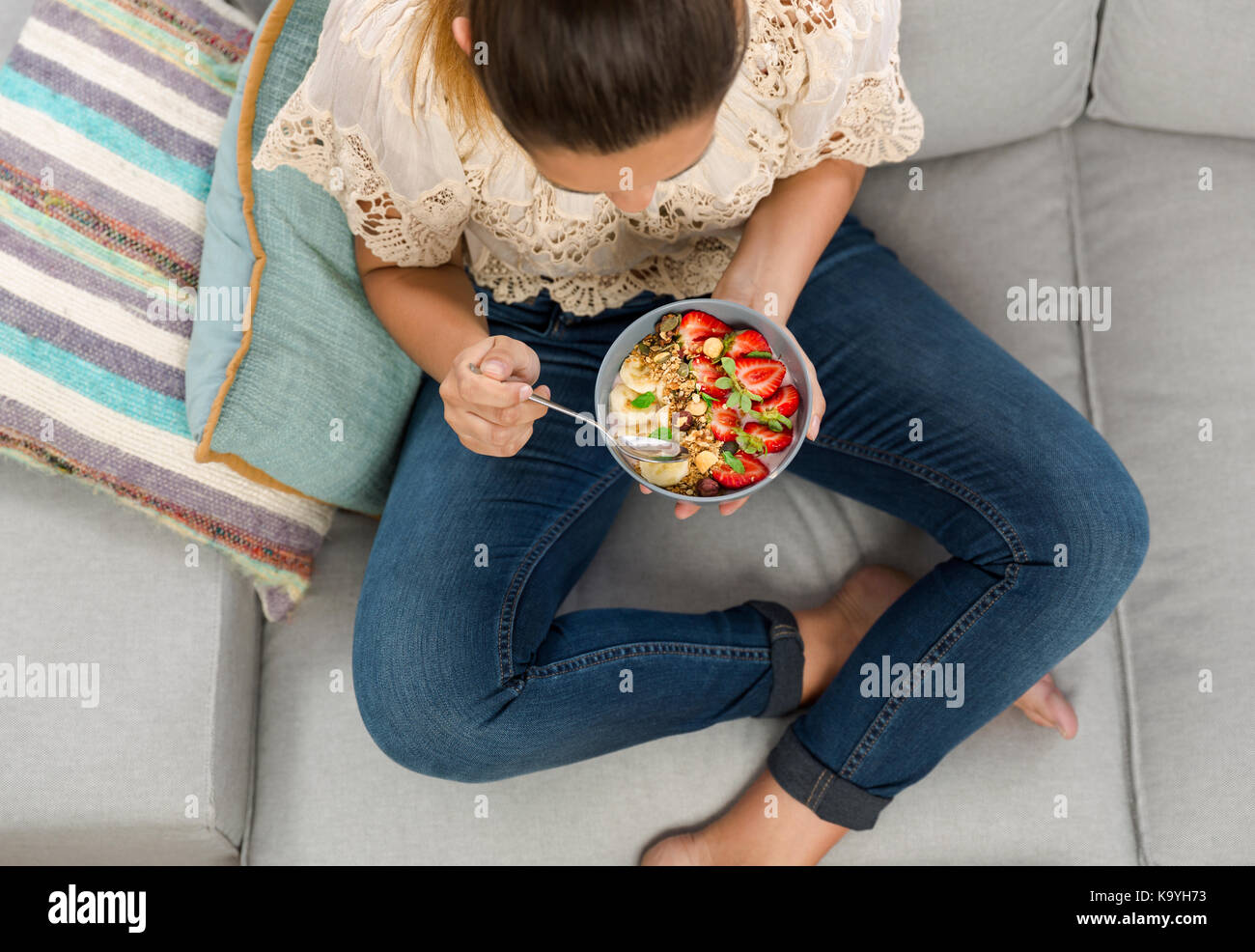 Beautiful happy woman at home eating a healthy bowl Stock Photo