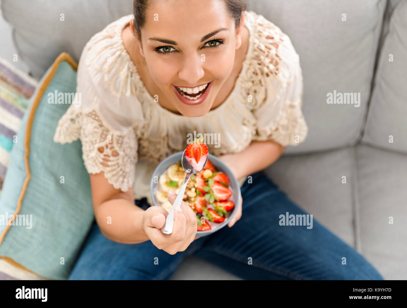 Beautiful happy woman at home eating a healthy bowl Stock Photo