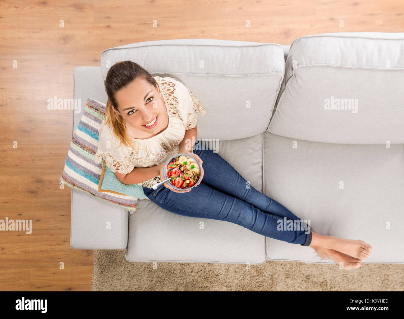 Top viw of a beautiful woman at home eating a healthy bowl Stock Photo