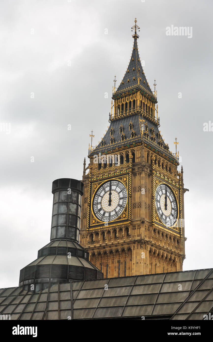 The top of Big Ben, The British Parliament Elizabeth Tower at 12 noon, and rooftops in London England UK Stock Photo