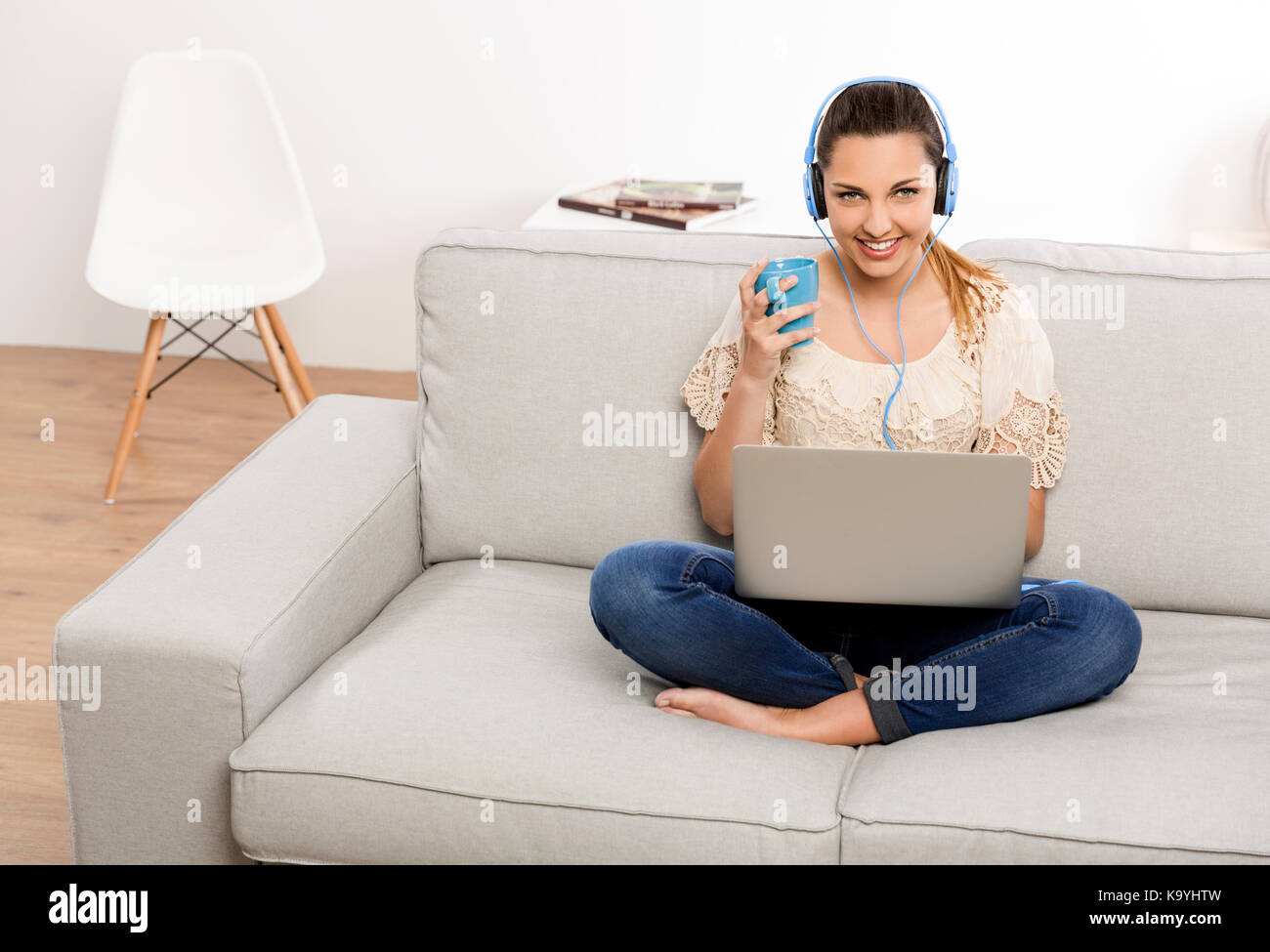 Beautiful woman at home working on her laptop and listening music Stock ...