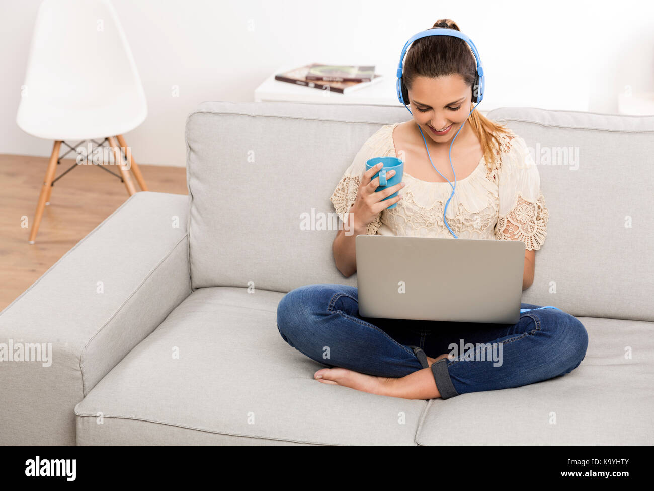 Beautiful woman at home working on her laptop and listening music Stock ...