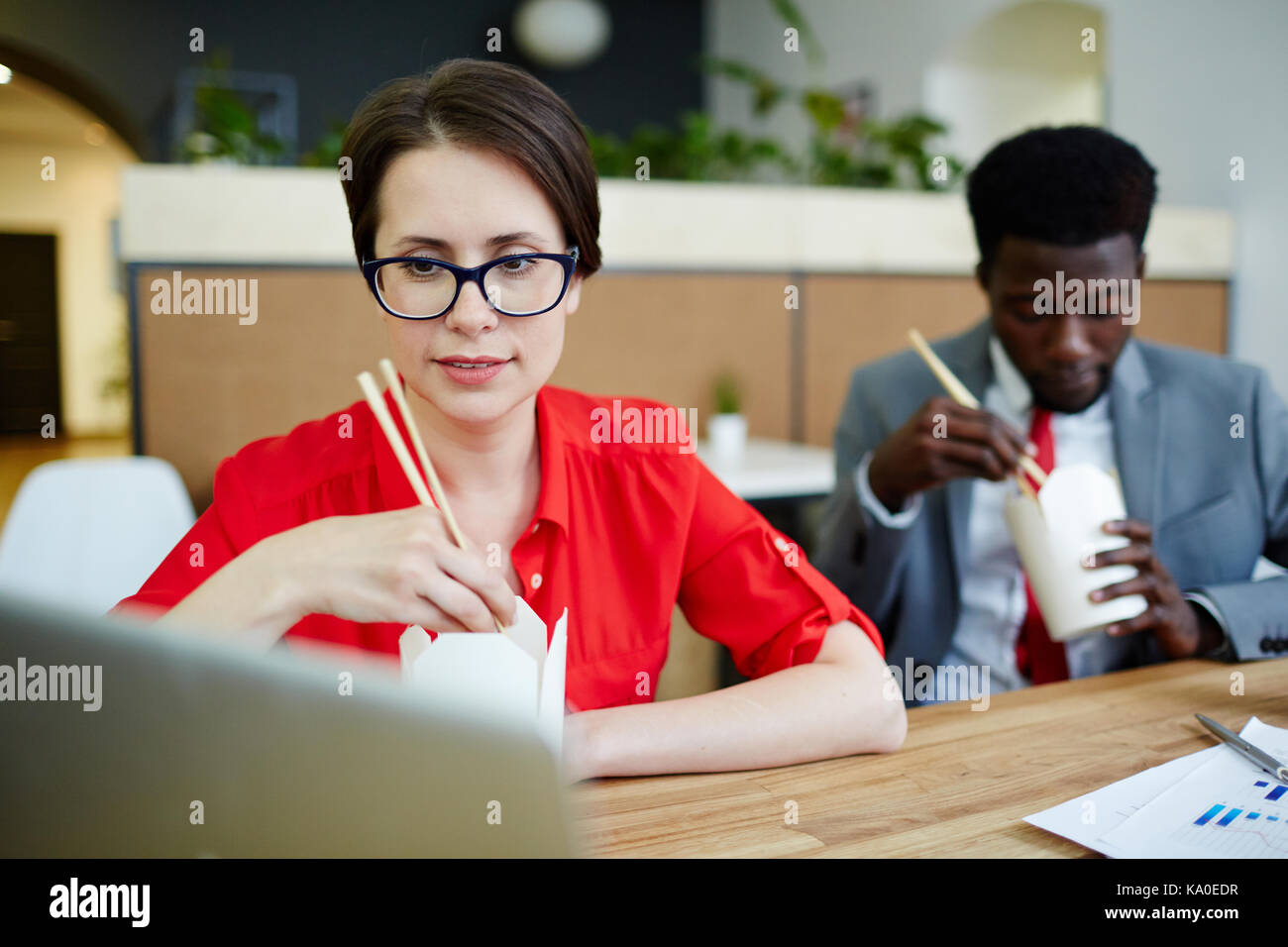 Busy Managers Having Lunch at Office Stock Photo