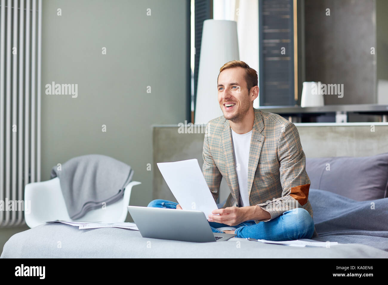 Cheerful Freelancer Working on Project Stock Photo