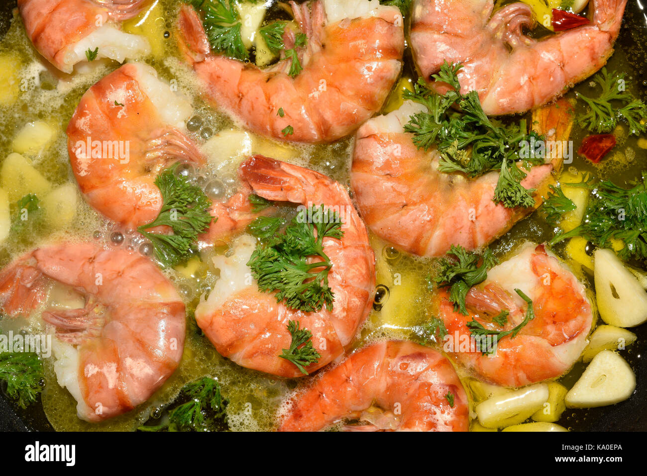 King prawns, tiger shrimps, with garlic and parsley in a pan, Canary Islands, Spain Stock Photo