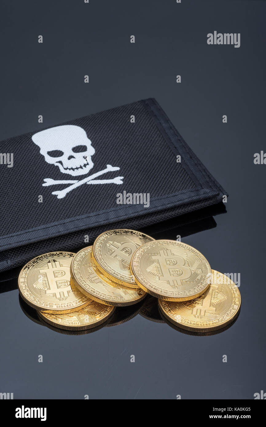 Bitcoin cryptorcurrency tokens on a black Jolly Roger wallet - metaphor for online transactions, Darkweb cybercrime, e-commerce. and digital wallet. Stock Photo